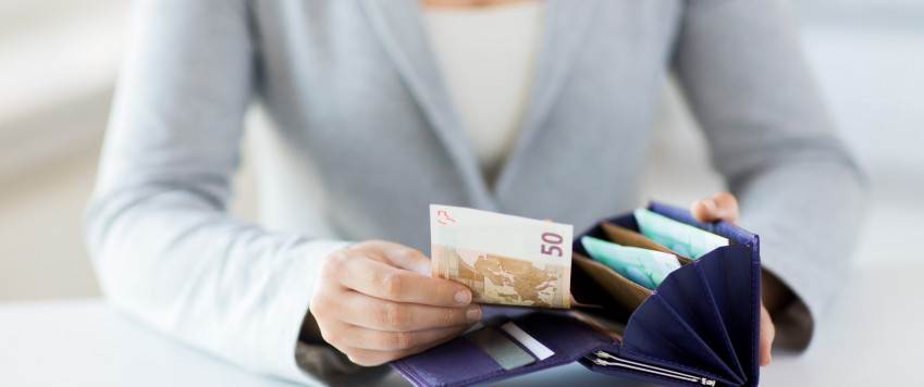 Female counting money, illustrative picture