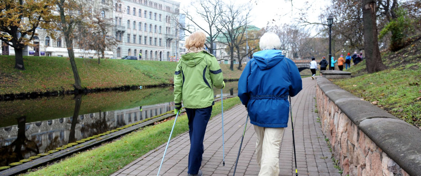 Illustrative photography with two women walking along the Riga canal