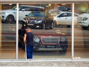 Window cleaner looks inside luxury car shop, illustratice picture