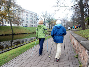 Illustrative photography with two women walking along the Riga canal
